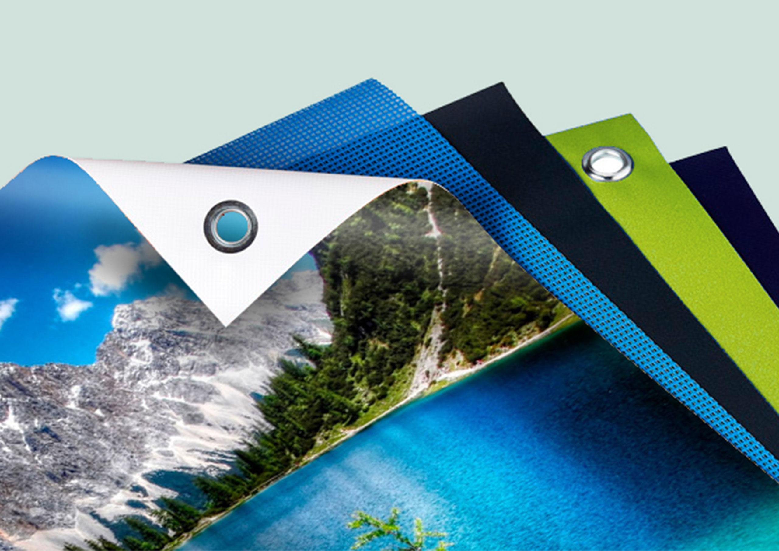 Diferentes tipos de lonas de PVC con ojales metálicos y acabados variados impresas por Gabella Artes Gráficas en Norte, Sevilla, ideales para publicidad exterior de alta resistencia.